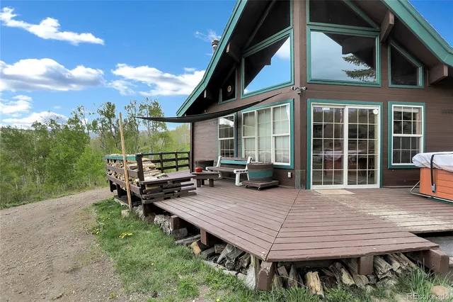 a view of a backyard with plants and large tree