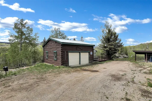 a view of a pathway both side of grassy field with shrub