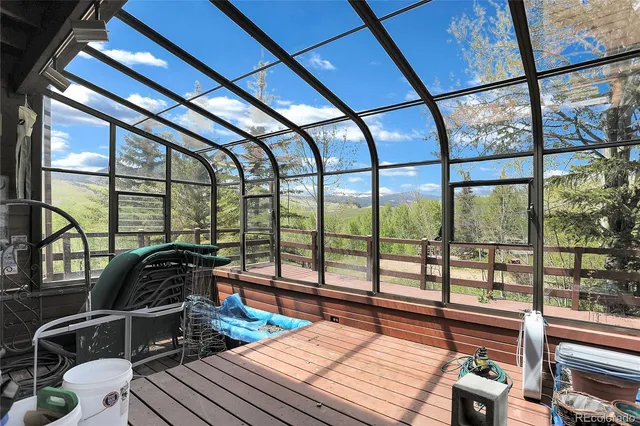 a view of a porch with furniture and front door