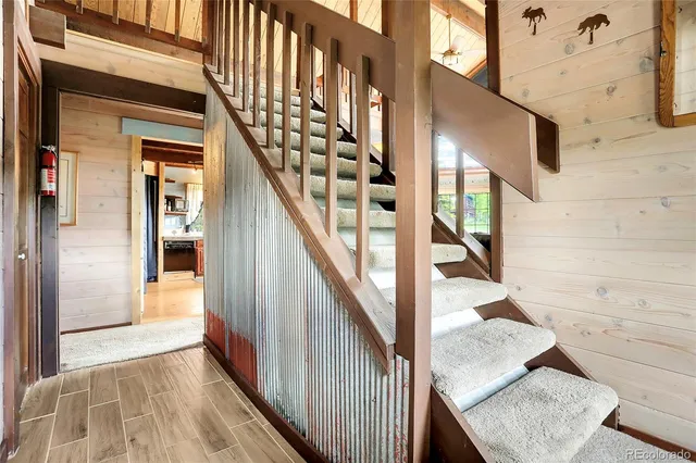 a dining room with furniture and a large window