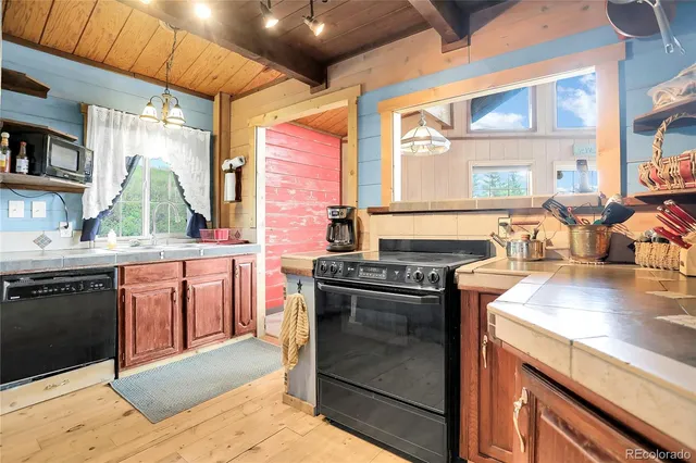 a kitchen with stainless steel appliances granite countertop a sink and a stove