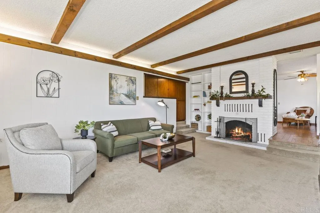 6825 Kellyn Lane Vista, CA 92084 - Photo 14 of 65 a living room with furniture a fireplace and a flat screen tv