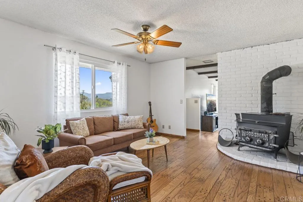 6825 Kellyn Lane Vista, CA 92084 - Photo 15 of 65 a living room with furniture and a chandelier