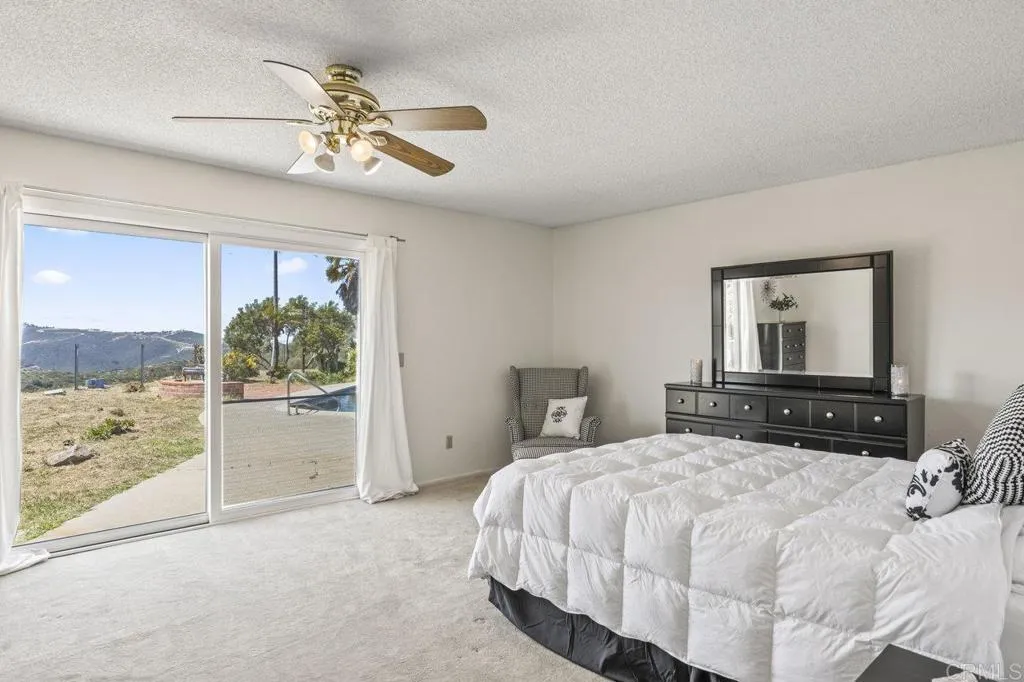 6825 Kellyn Lane Vista, CA 92084 - Photo 24 of 65 a bedroom with a bed and a window