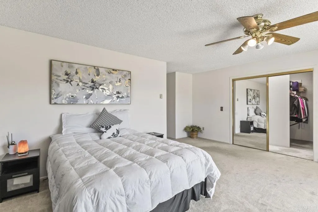 6825 Kellyn Lane Vista, CA 92084 - Photo 28 of 65 a bedroom with a bed and a painting on the wall