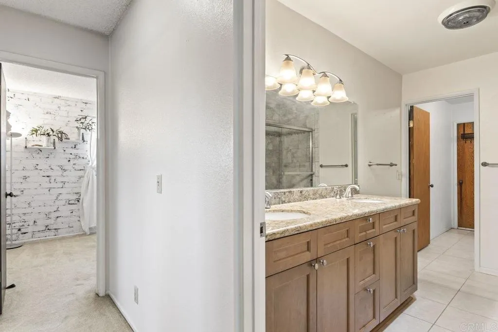 6825 Kellyn Lane Vista, CA 92084 - Photo 36 of 65 a bathroom with a sink and a mirror