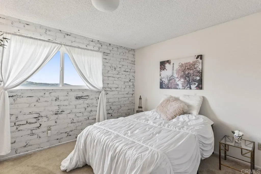 6825 Kellyn Lane Vista, CA 92084 - Photo 37 of 65 a bedroom with a bed and a window