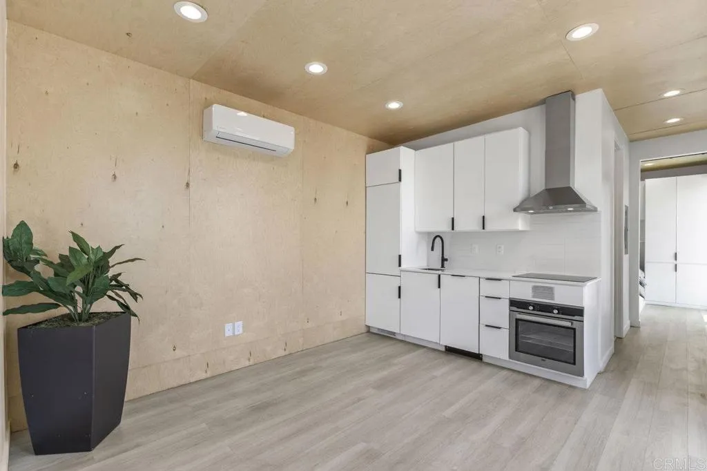 6825 Kellyn Lane Vista, CA 92084 - Photo 45 of 65 a kitchen with white cabinets and a stove