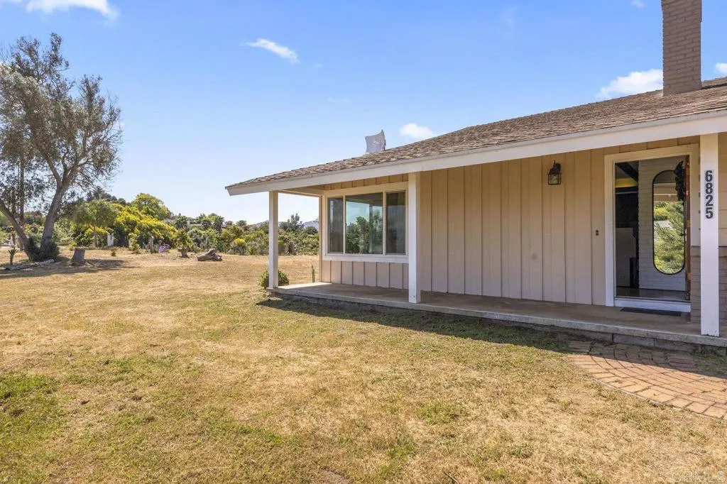 6825 Kellyn Lane Vista, CA 92084 - Photo 10 of 65 a view of backyard with large trees and plants