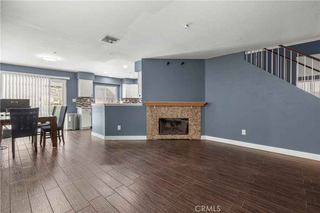 15417 Tobarra Road Fontana, CA 92337 - Photo 10 of 29 a view of a livingroom with furniture and a fireplace
