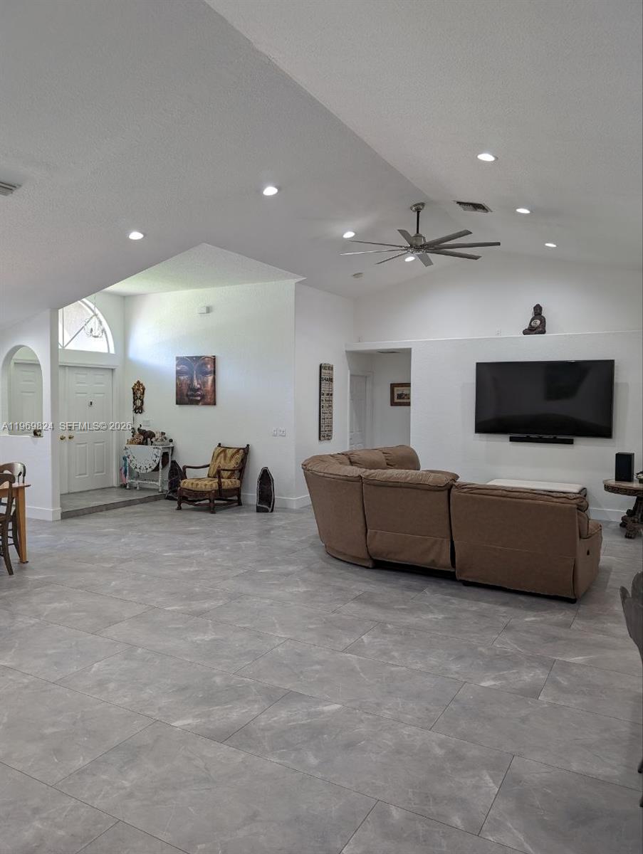 10920 Barn Road Lake Worth, FL 33449 - Photo 14 of 19 a living room with furniture and a flat screen tv