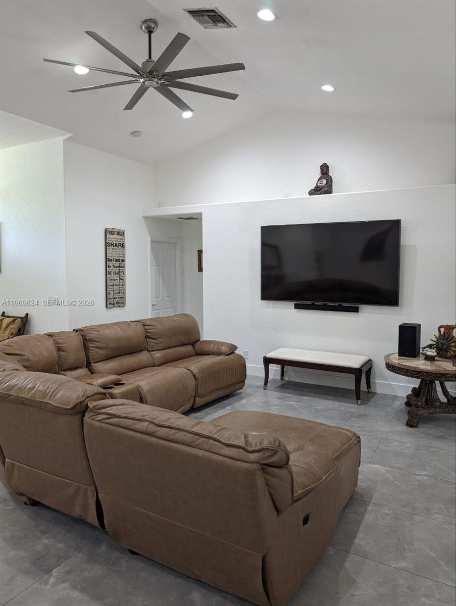 10920 Barn Road Lake Worth, FL 33449 - Photo 15 of 19 a living room with furniture and a flat screen tv