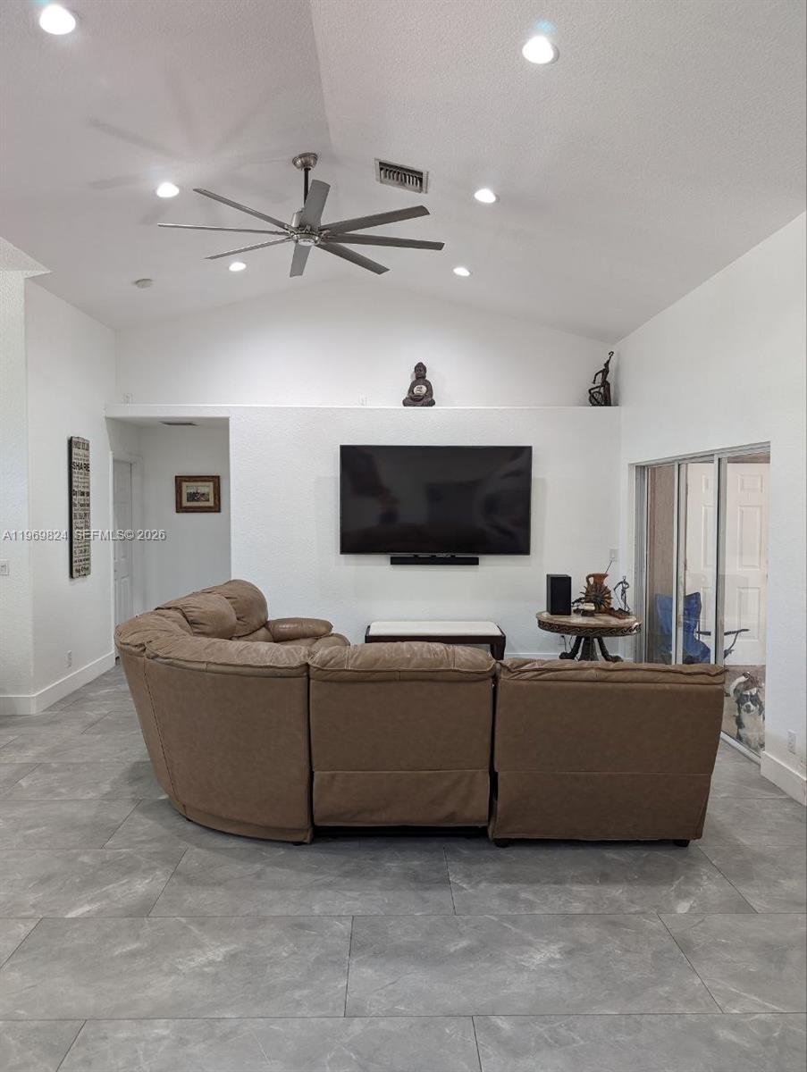 10920 Barn Road Lake Worth, FL 33449 - Photo 16 of 19 a living room with furniture and a flat screen tv