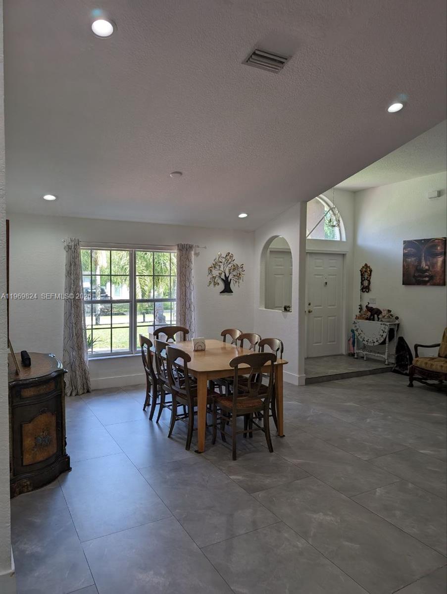 10920 Barn Road Lake Worth, FL 33449 - Photo 17 of 19 a view of a dining room with furniture and chandelier