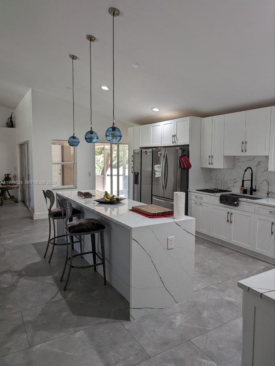 10920 Barn Road Lake Worth, FL 33449 - Photo 18 of 19 a kitchen with stainless steel appliances granite countertop a sink counter space and cabinets