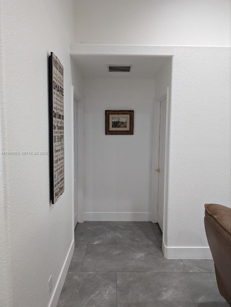 10920 Barn Road Lake Worth, FL 33449 - Photo 10 of 19 a view of an empty room with windows