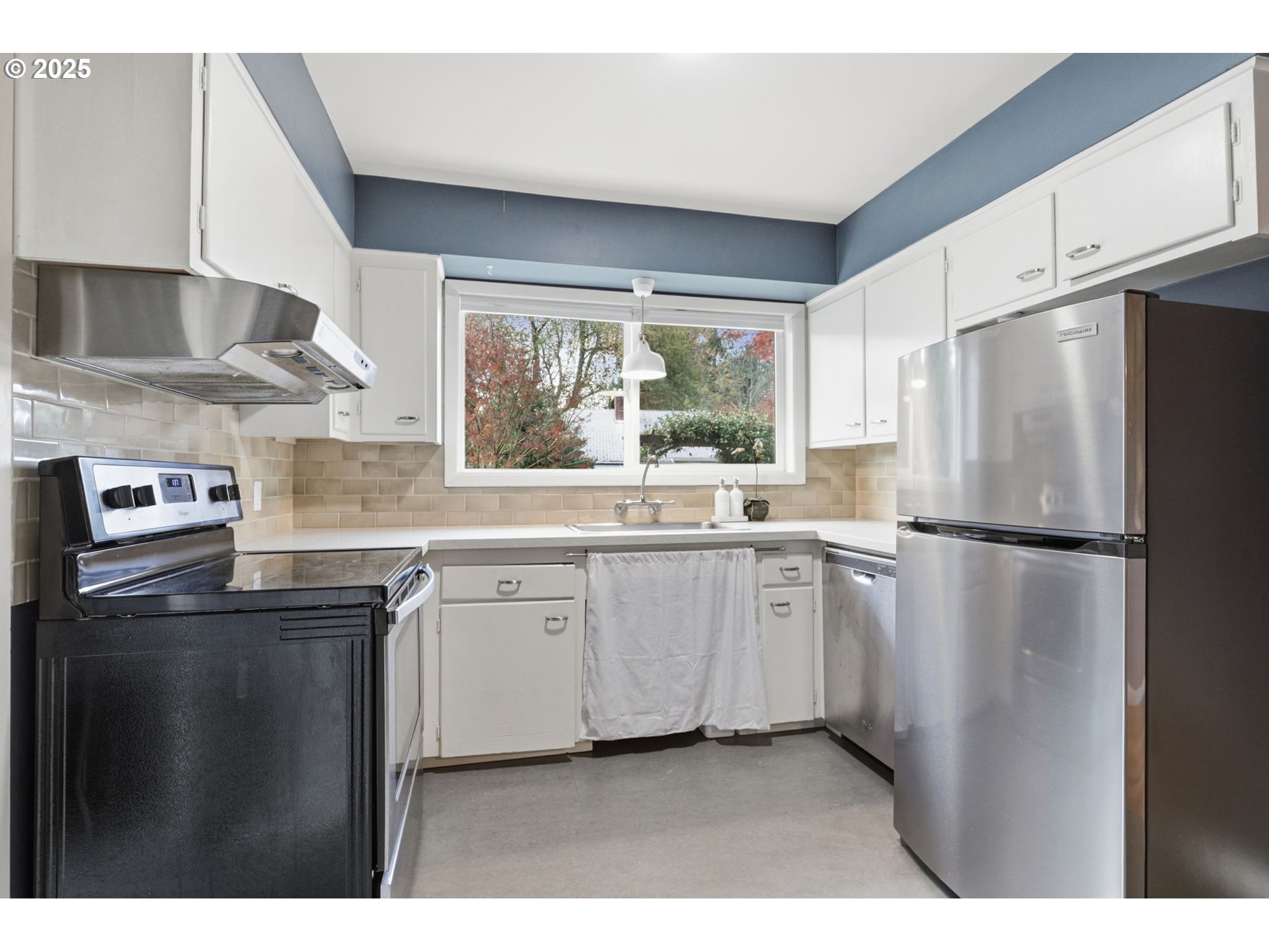 8502 North Hamlin Avenue Portland, OR 97217 - Photo 11 of 48 a kitchen with stainless steel appliances a refrigerator sink and window