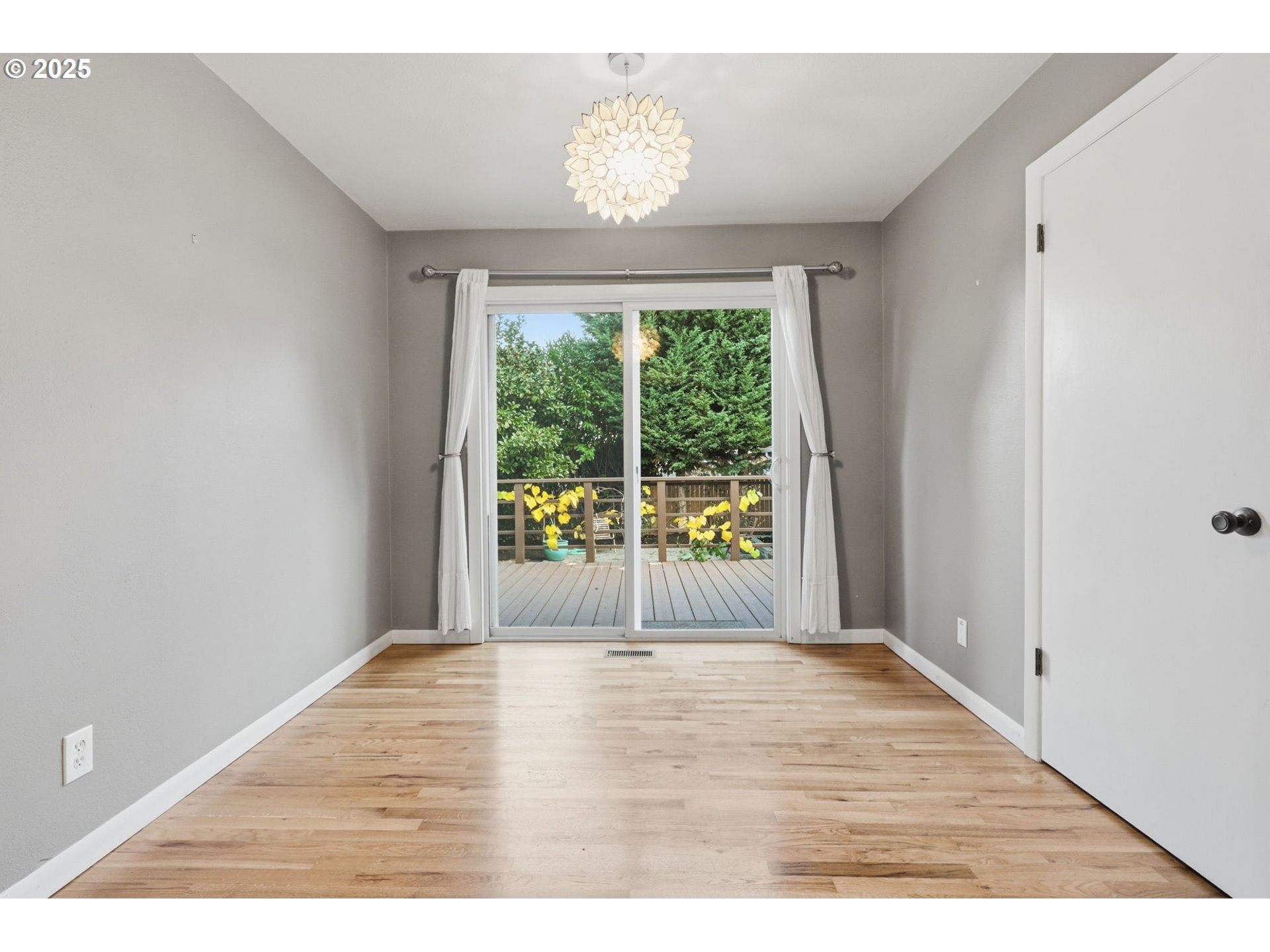 8502 North Hamlin Avenue Portland, OR 97217 - Photo 17 of 48 a view of an empty room with wooden floor and a window