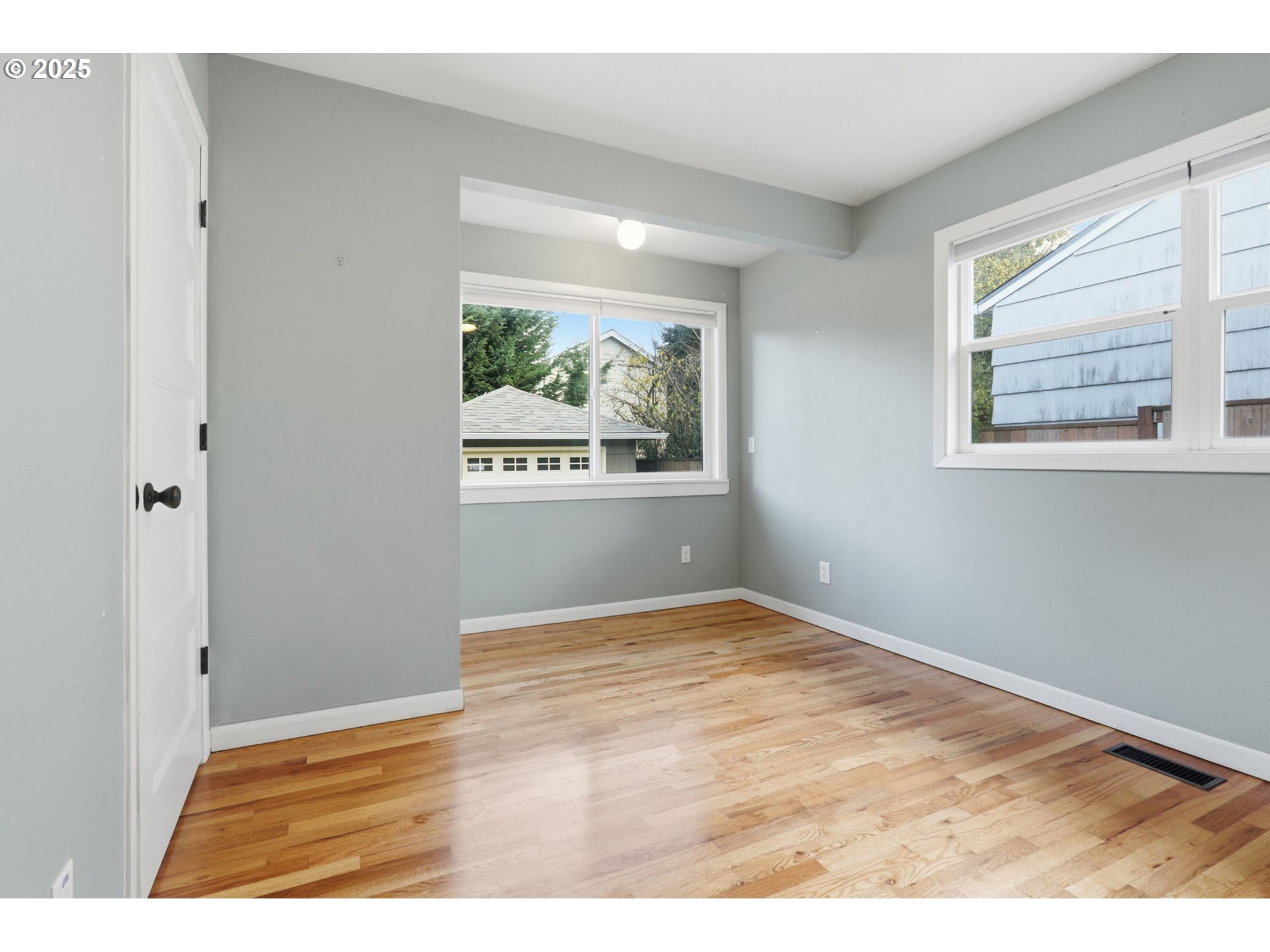8502 North Hamlin Avenue Portland, OR 97217 - Photo 19 of 48 a view of an empty room with wooden floor and a window