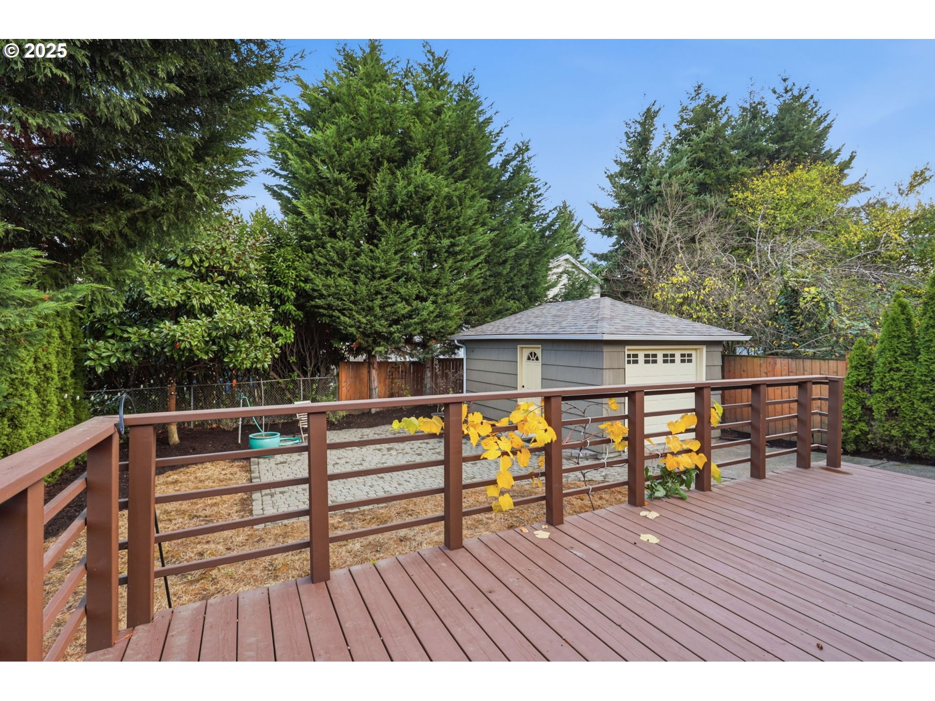 8502 North Hamlin Avenue Portland, OR 97217 - Photo 26 of 48 a view of house with deck outdoor seating and trees in the background