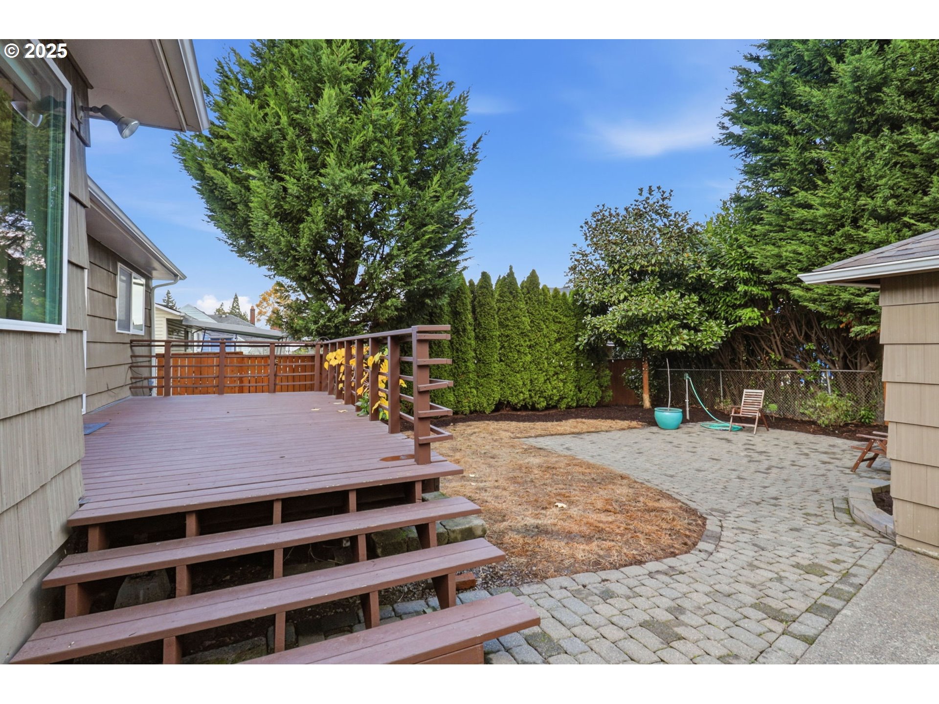 8502 North Hamlin Avenue Portland, OR 97217 - Photo 28 of 48 a backyard of a house with table and chairs with plants and wooden fence