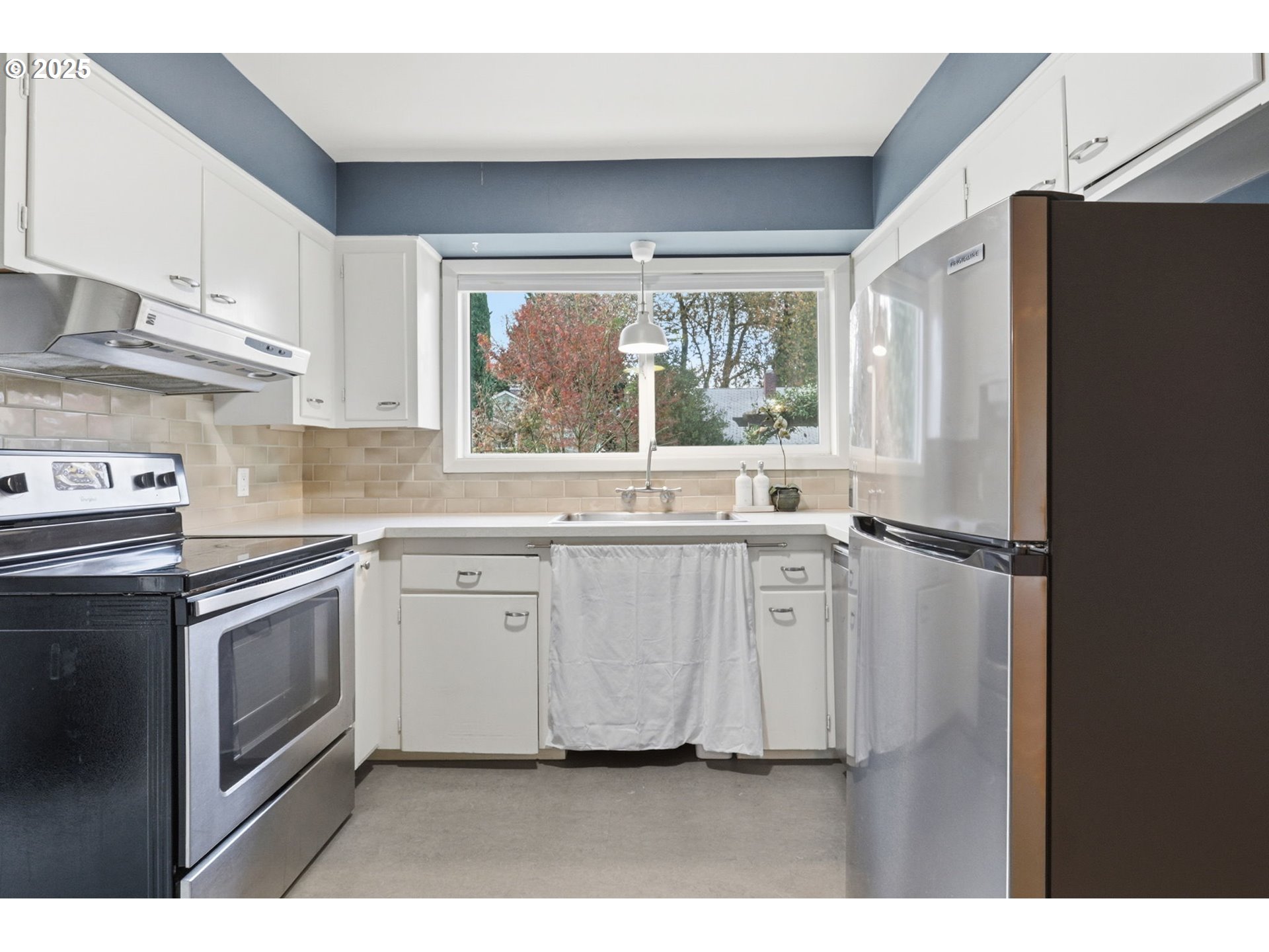 8502 North Hamlin Avenue Portland, OR 97217 - Photo 9 of 48 a kitchen with stainless steel appliances a sink cabinets and a window