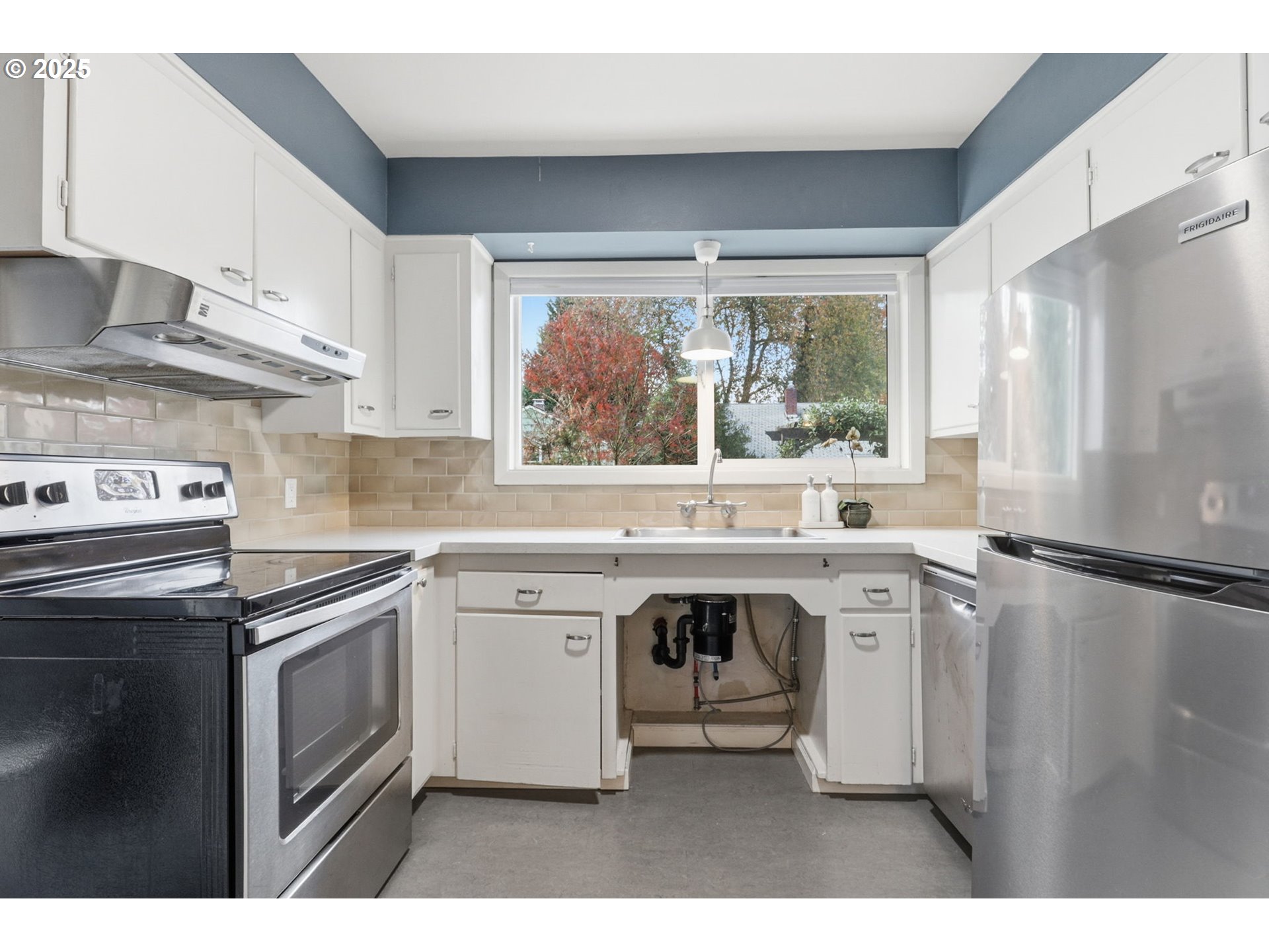 8502 North Hamlin Avenue Portland, OR 97217 - Photo 10 of 48 a kitchen with a sink stove and refrigerator