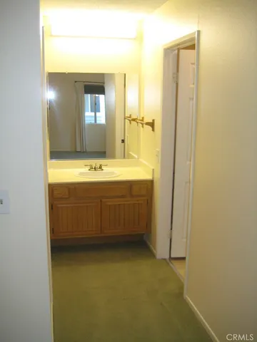 a view of a bathroom with sink and mirror