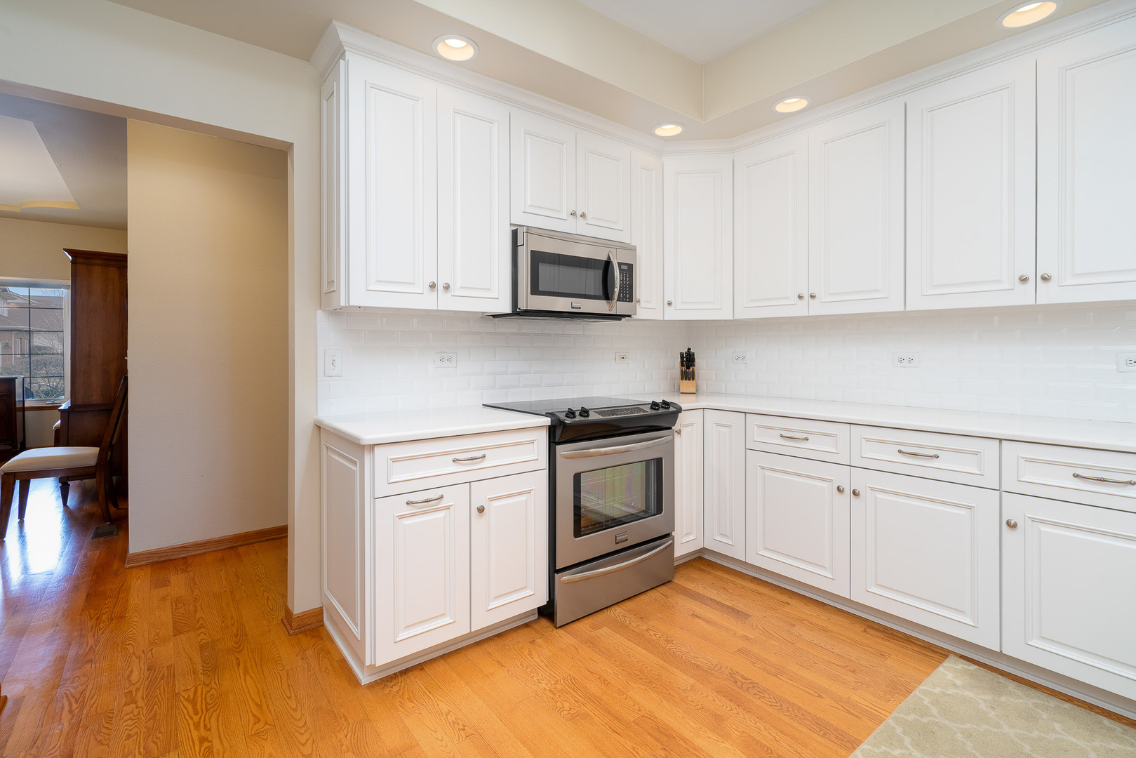 16551 SpringView Drive Lockport, IL 60441 - Photo 8 of 47 a kitchen with granite countertop white cabinets and white appliances