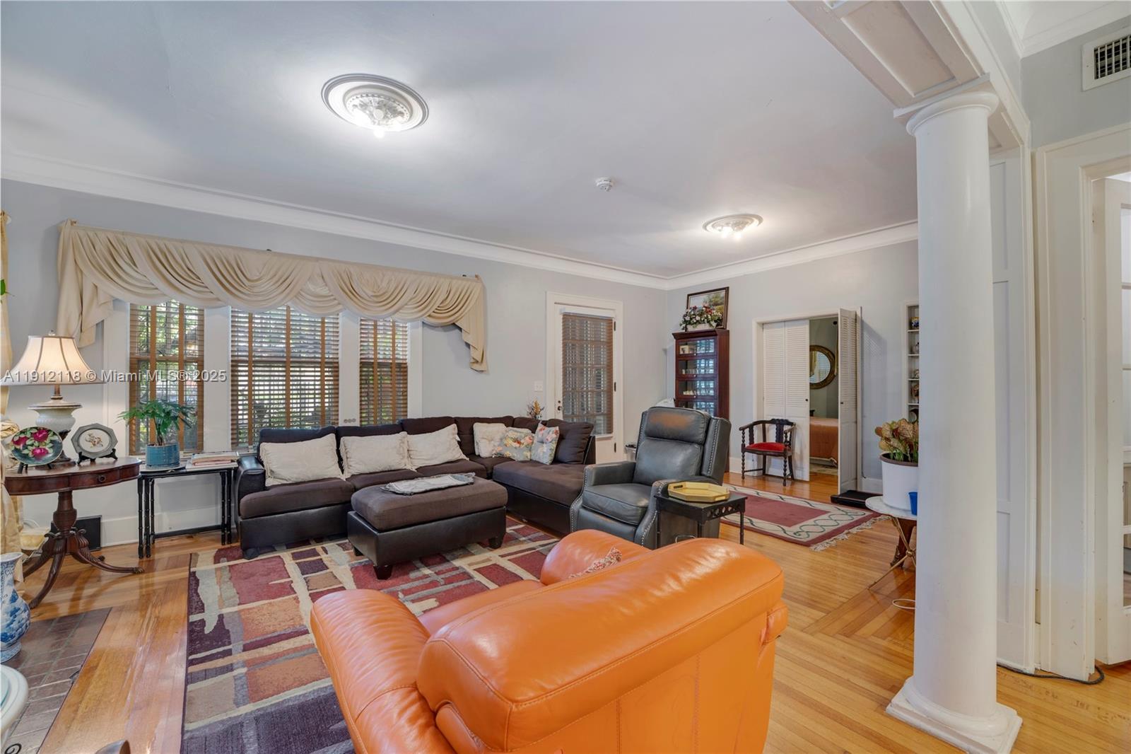 405 Southwest 11th Avenue Miami, FL 33130 - Photo 4 of 26 a living room with furniture a large window and wooden floor
