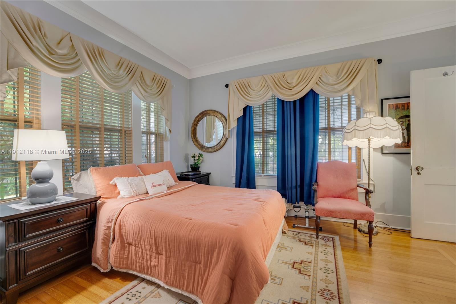 405 Southwest 11th Avenue Miami, FL 33130 - Photo 8 of 26 a bedroom with a bed and dresser with wooden floor