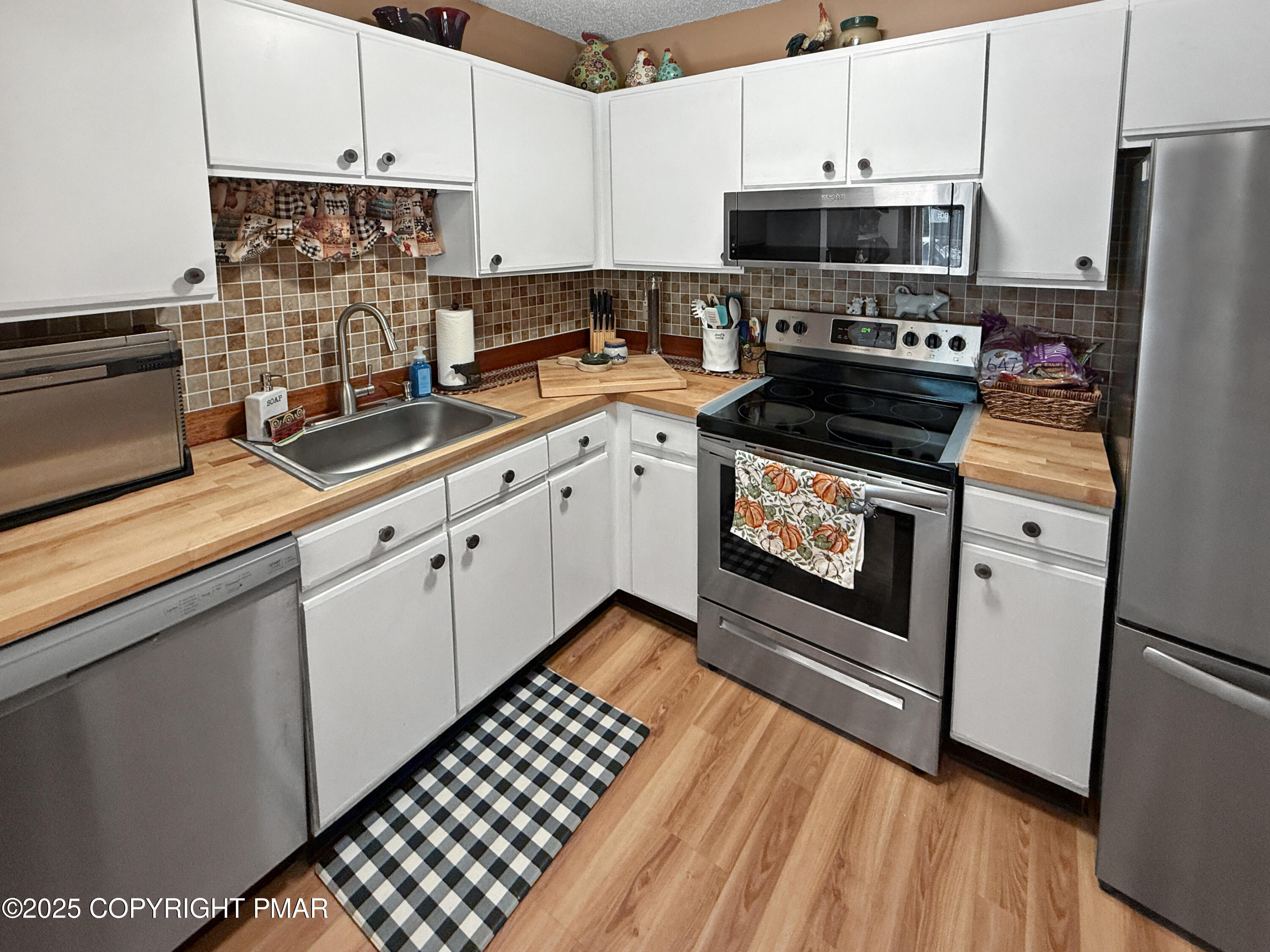274 Nittany Court Mount Pocono, PA 18344 - Photo 7 of 28 a kitchen with stainless steel appliances a stove a sink and a refrigerator