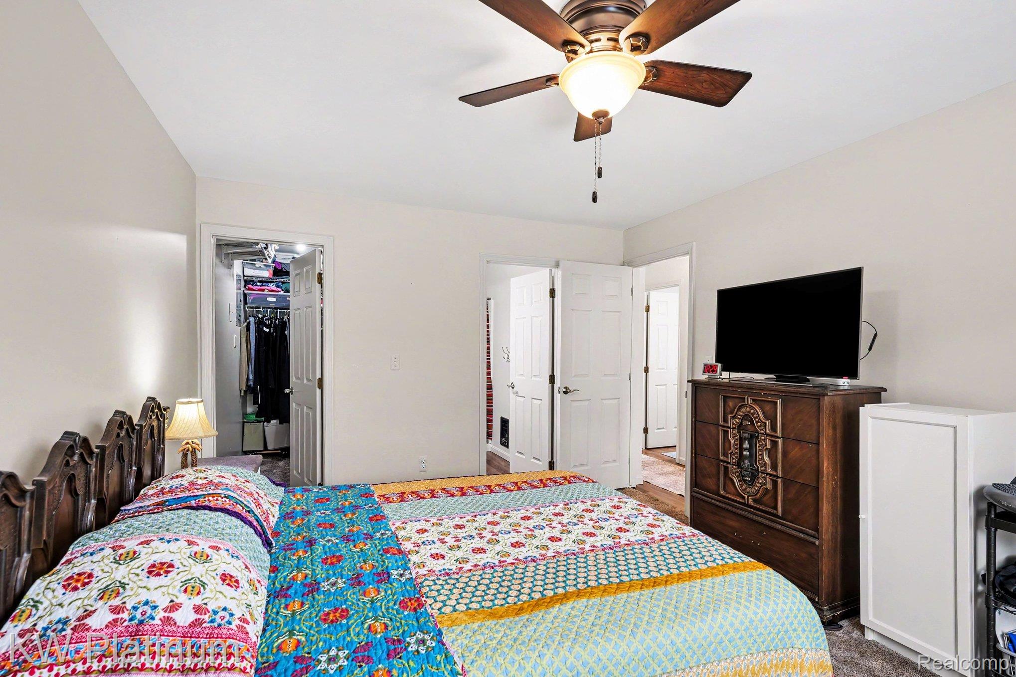 1700 River Road, Unit 6 Marysville, MI 48040 - Photo 16 of 32 Bedroom featuring a ceiling fan with integrated lighting, wood-finish flooring visible through an open doorway, and a closet with an open doorway