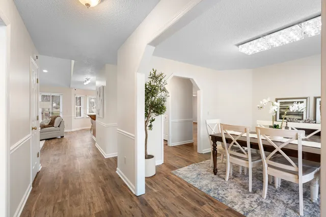 a view of a dining room with furniture and wooden floor
