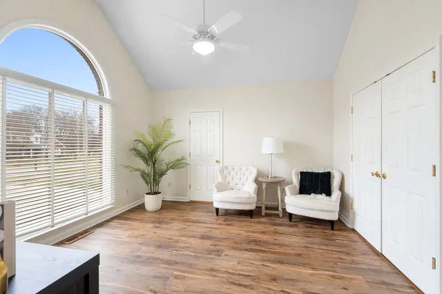 a living room with furniture and wooden floor