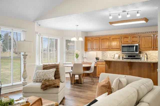 a large kitchen with a table and chairs