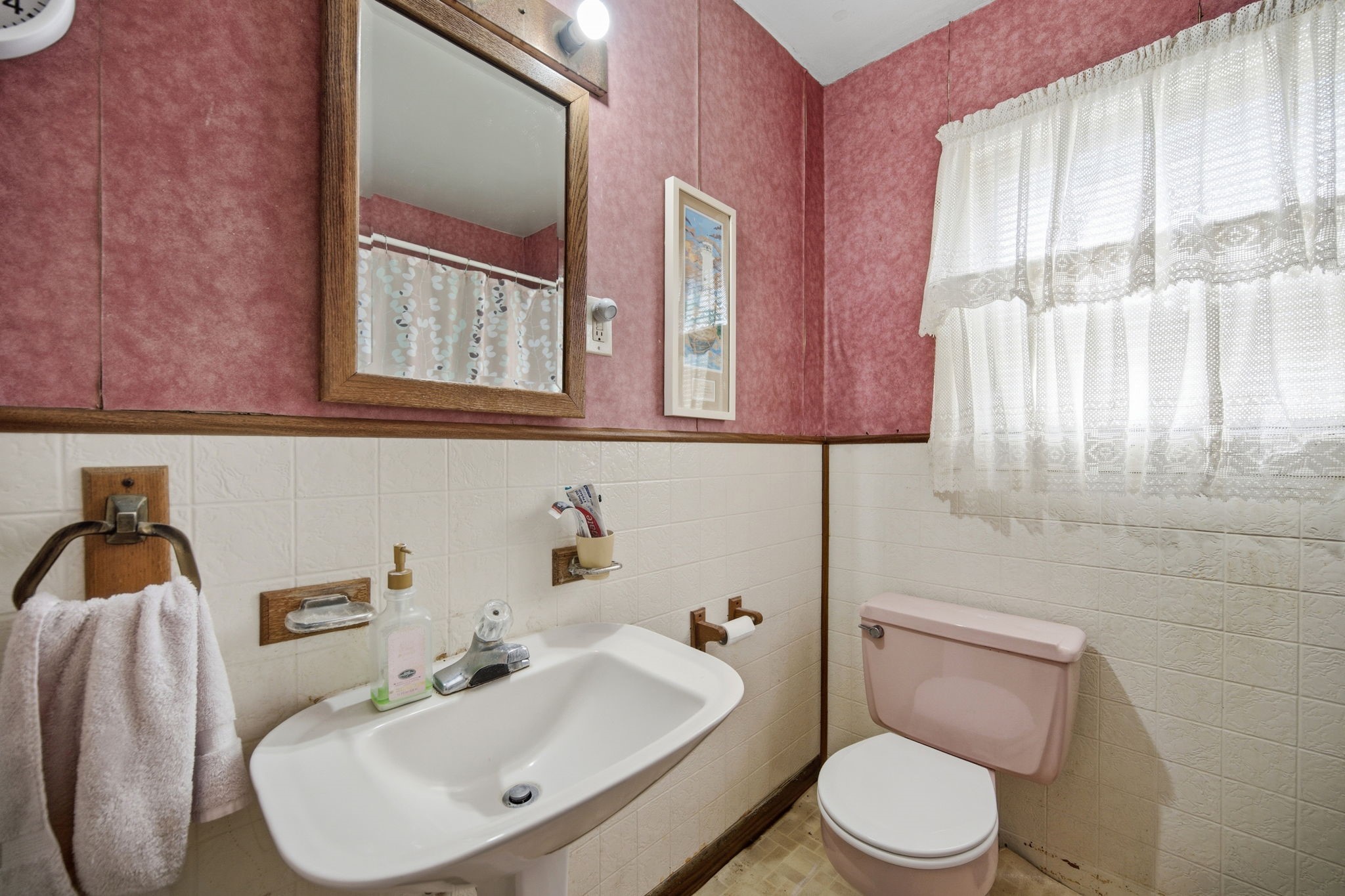 1604 Kipling Street Liberty, TX 77575 - Photo 14 of 19 a bathroom with a toilet a sink and mirror