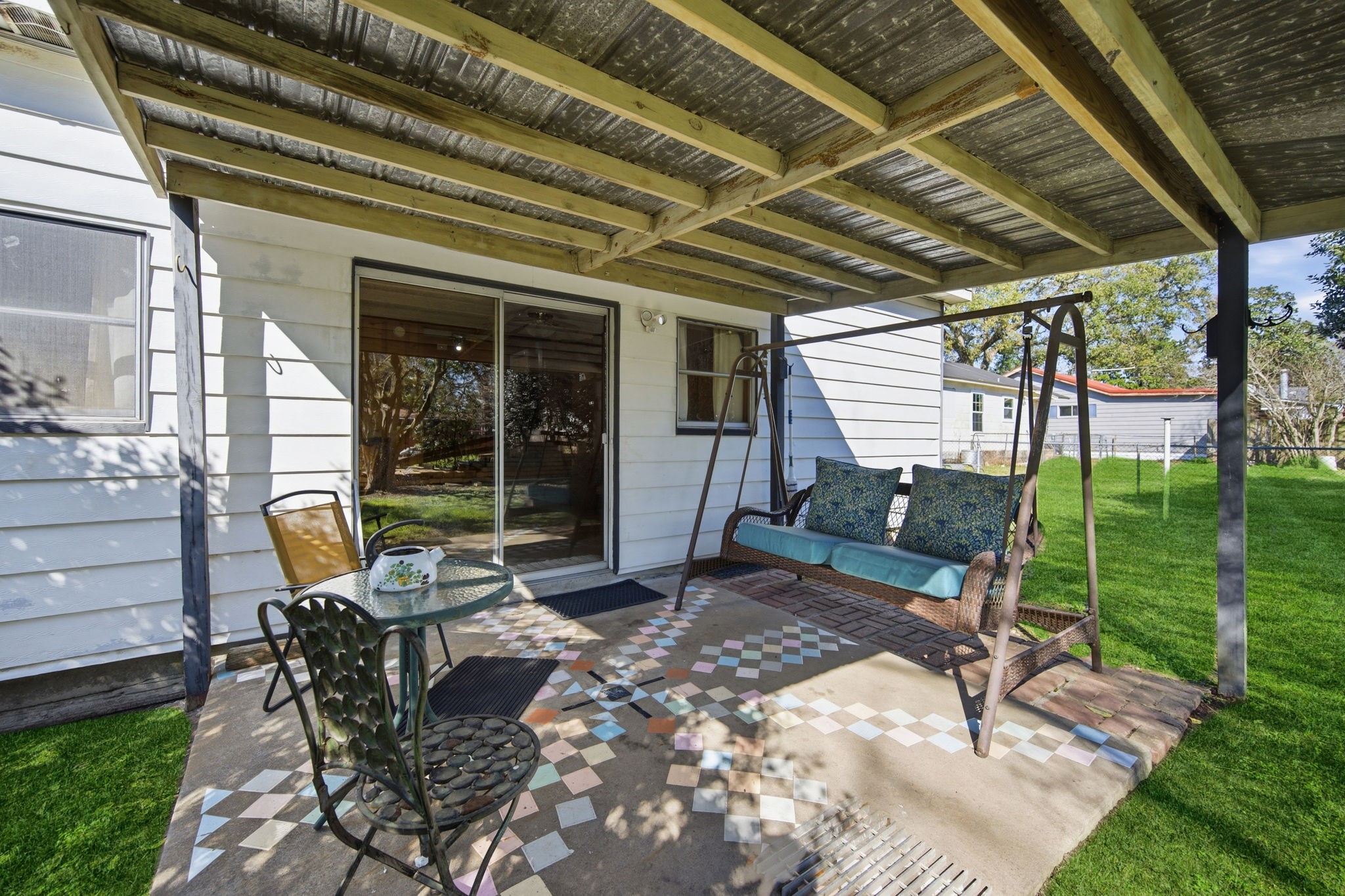 1604 Kipling Street Liberty, TX 77575 - Photo 17 of 19 a view of a backyard with table and chairs and wooden fence