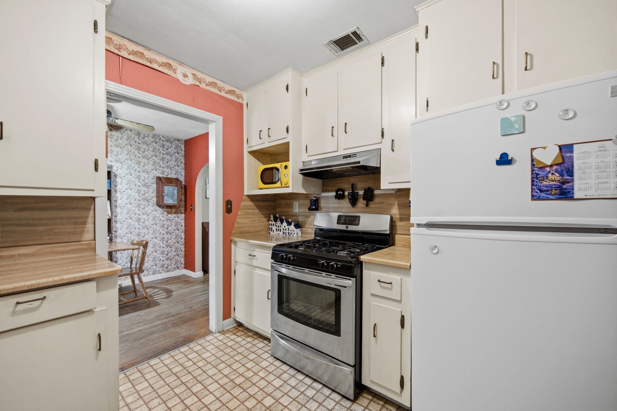 1604 Kipling Street Liberty, TX 77575 - Photo 9 of 19 a kitchen with stainless steel appliances a stove a refrigerator and cabinets