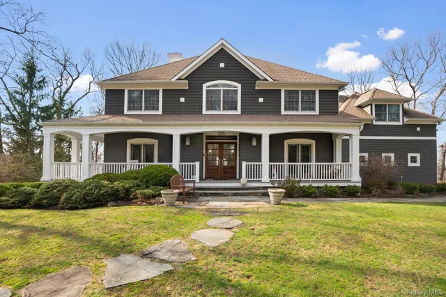 a front view of a house with yard and green space