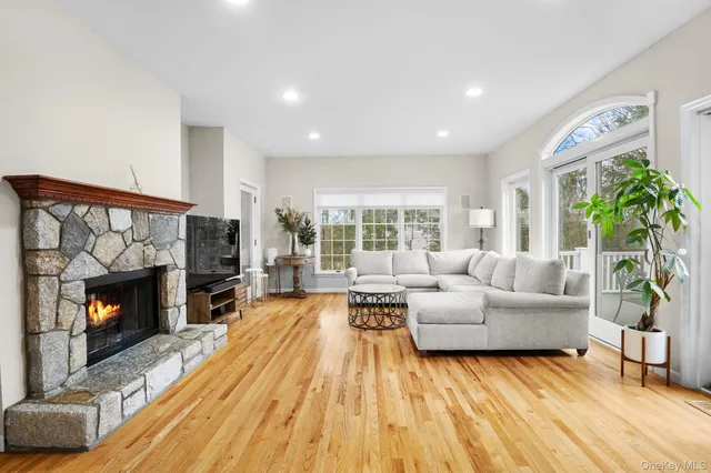 a view of an empty room with a fireplace and a window