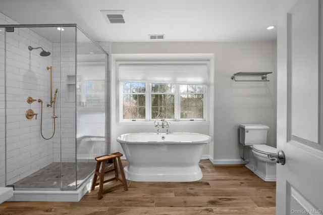 a bathroom with a granite countertop sink mirror and shower
