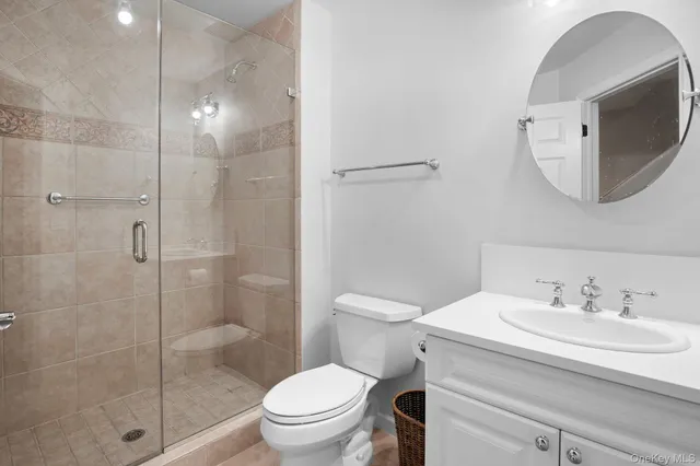 a bathroom with a sink toilet and mirror