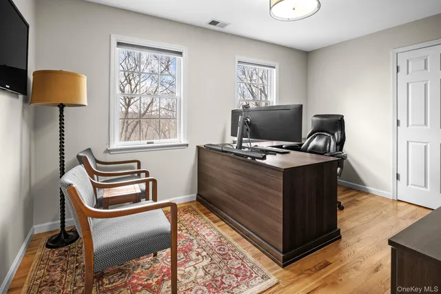 a bathroom with a toilet a sink a mirror a bathtub and shower