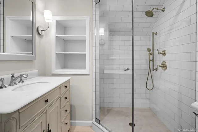 a spacious bedroom with a bed a couch and window