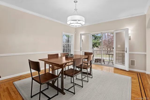 a view of a dining room with furniture wooden floor and a chandelier