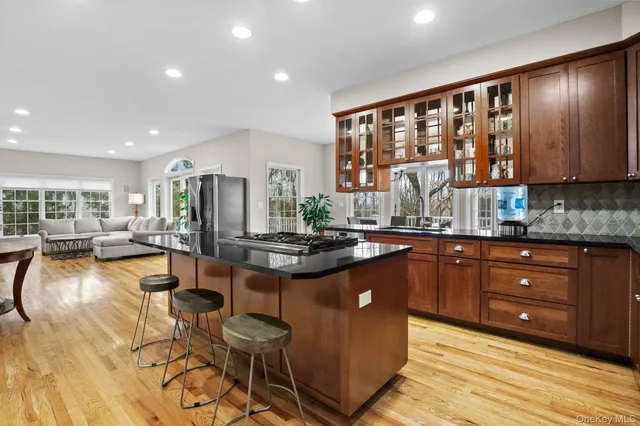 a kitchen with stainless steel appliances granite countertop a stove and cabinets