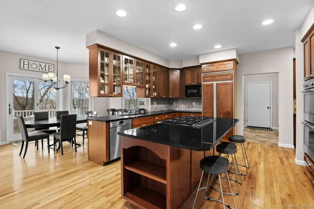 a kitchen with stainless steel appliances granite countertop a stove refrigerator and cabinets