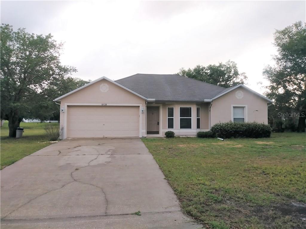 10520 Blythville Road Spring Hill, FL 34608 - Photo 1 of 1 a front view of a house with a yard and garage