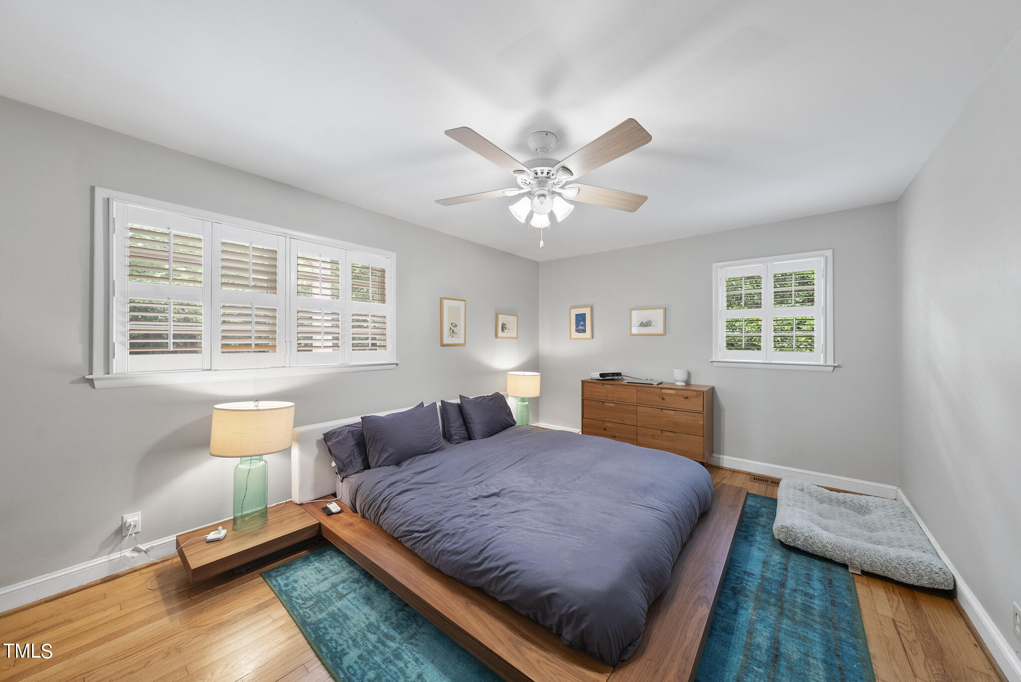 819 Beaver Dam Road Raleigh, NC 27607 - Photo 13 of 28 a bedroom with a bed and wooden floor